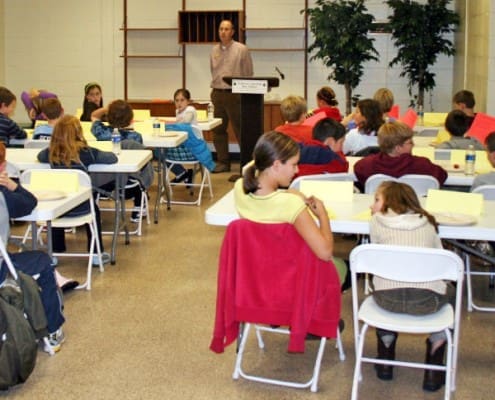 Students listening to a speaker in a classroom at the Anderson Parks RecPlex