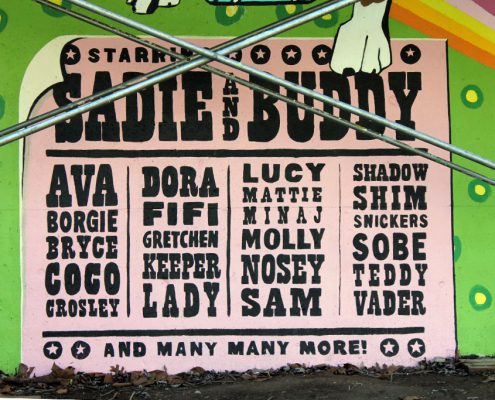 Kellogg Park Dog Field mural detail - an old-school-movie-style poster with dogs' names.