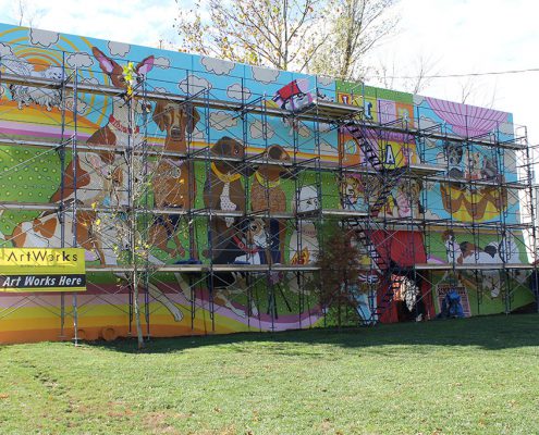 Kellogg Park Dog Field mural under construction by Artworks