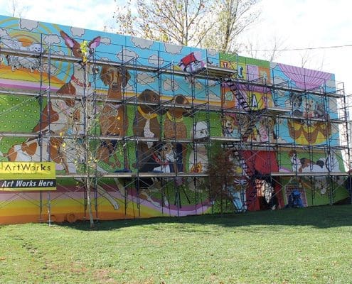 Kellogg Park Dog Field mural under construction by Artworks