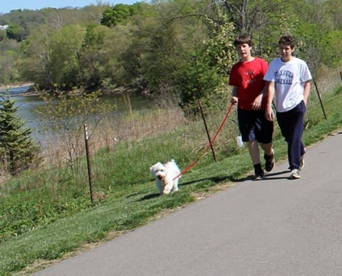 Riverside Park hike/bike trail two boys walking a dog on the Riverside Park hike/bike trail