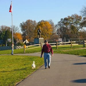 Beech Acres Park trail A man walks his small dog on the paved trail at Beech Acres Park Skatepark