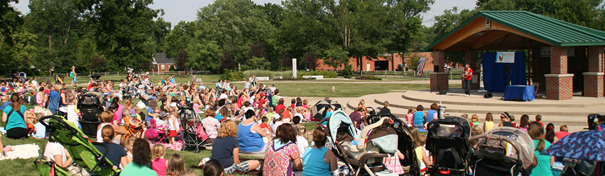 Large crowd in front of the amphitheater as their entertained by children's performer, Zak Morgan