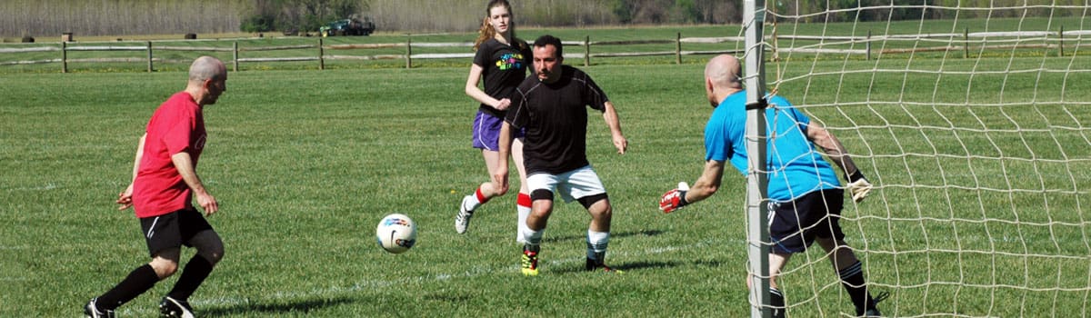 Park district's 11v11 co-rec soccer players at Clear Creek Park. Soccer players trying to score a goal
