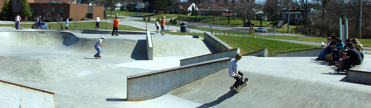 Spectators and skateboarders enjoying the warm weather at the skatepark
